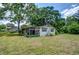Side view of house with screened-in porch and lush green yard at 38839 Miller Ave, Zephyrhills, FL 33542