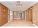 Large living room features wood-look flooring, wood walls and an open-concept layout at 38839 Miller Ave, Zephyrhills, FL 33542