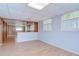 Living room showcasing wood walls, bright windows, and wood-look flooring at 38839 Miller Ave, Zephyrhills, FL 33542