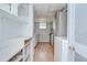 Pantry with open shelving next to kitchen with stainless refrigerator and gas range at 38839 Miller Ave, Zephyrhills, FL 33542