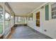 Screened porch with concrete flooring, white trim, and a view of the front yard at 38839 Miller Ave, Zephyrhills, FL 33542