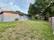 Spacious backyard with a mature tree and partial fencing at 404 Water St, Plant City, FL 33563