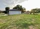 Spacious backyard with mature trees, green lawn, and wooden fence at 404 Water St, Plant City, FL 33563