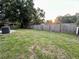 Large backyard with wooden fence, mature trees, and green lawn at 404 Water St, Plant City, FL 33563