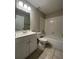 Bathroom with a white vanity, bathtub and tiled shower, and neutral wall colors at 404 Water St, Plant City, FL 33563