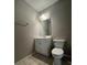 Cozy bathroom featuring a single sink vanity, mirror, and tile flooring at 404 Water St, Plant City, FL 33563
