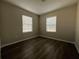 A minimalist bedroom with hardwood floors, natural lighting, and neutral-colored walls at 404 Water St, Plant City, FL 33563