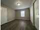 Bedroom with wood-look flooring, natural light, and a double-door closet at 404 Water St, Plant City, FL 33563