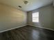 Neutral bedroom featuring wood-look flooring and a bright window at 404 Water St, Plant City, FL 33563