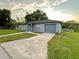 Charming home with a driveway, attached garage, and well-maintained lawn at 404 Water St, Plant City, FL 33563