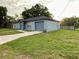 Well-kept home featuring gray exterior paint, a neatly manicured lawn, and an attached garage at 404 Water St, Plant City, FL 33563