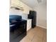 A compact kitchen featuring black appliances, marble countertops, and light-colored cabinetry at 404 Water St, Plant City, FL 33563