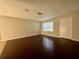 Open living area with hardwood floors, a front door, and neutral wall colors at 404 Water St, Plant City, FL 33563