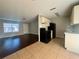 Inviting living room and kitchen space with hardwood floors and black appliances at 404 Water St, Plant City, FL 33563