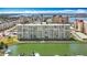 An aerial view of a waterfront apartment complex in a residential area with boats docked nearby at 4725 Cove Circle # 908, St Petersburg, FL 33708
