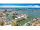 Aerial view featuring a beautiful coastal property, a serene lake, and tennis courts for recreation at 4725 Cove Circle # 908, St Petersburg, FL 33708