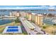 An aerial view of the condo complex, featuring views of tennis courts, the water, and parking at 4725 Cove Circle # 908, St Petersburg, FL 33708