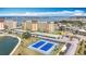 Beautiful aerial of condo complex featuring tennis courts, water views, parking and landscaping at 4725 Cove Circle # 908, St Petersburg, FL 33708
