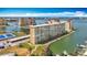 Aerial view of a large apartment complex on the water with parking, tennis courts and manicured landscaping at 4725 Cove Circle # 908, St Petersburg, FL 33708