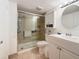 Bathroom with glass enclosed shower, vanity with double sink, and clean finishes at 4725 Cove Circle # 908, St Petersburg, FL 33708
