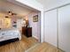 Bedroom features hardwood floors with views into the attached bathroom at 4725 Cove Circle # 908, St Petersburg, FL 33708