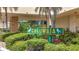The Columbia Condo community sign is surrounded by lush landscaping at 4725 Cove Circle # 908, St Petersburg, FL 33708