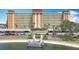 Waterfront condo building featuring lush landscaping, ample parking, and a private dock at 4725 Cove Circle # 908, St Petersburg, FL 33708