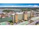 Aerial view of condo complex exterior elevation showcasing parking and waterfront at 4725 Cove Circle # 908, St Petersburg, FL 33708