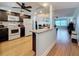 Open kitchen with a granite countertop island, dark cabinetry, and stainless steel appliances at 4725 Cove Circle # 908, St Petersburg, FL 33708