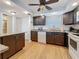 Bright kitchen featuring wood floors and dark cabinetry at 4725 Cove Circle # 908, St Petersburg, FL 33708