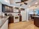 Kitchen featuring dark cabinetry, white appliances, and wood flooring at 4725 Cove Circle # 908, St Petersburg, FL 33708