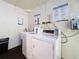 Coin operated laundry room with instructions posted, dark floors, and available laundry card reader at 4725 Cove Circle # 908, St Petersburg, FL 33708