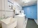 Well-lit laundry room with a utility sink, coin operated washer and dryer and assigned storage lockers at 4725 Cove Circle # 908, St Petersburg, FL 33708