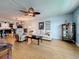 Inviting living room featuring a ceiling fan, plush seating, and seamless access to the kitchen at 4725 Cove Circle # 908, St Petersburg, FL 33708