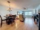 Open living space featuring wood floors, a dining table, and waterfront views at 4725 Cove Circle # 908, St Petersburg, FL 33708