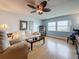Bright living room featuring a large window, comfortable seating, and wood floors at 4725 Cove Circle # 908, St Petersburg, FL 33708
