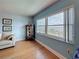 Bright living room features a large window with a view, neutral paint, and wood flooring at 4725 Cove Circle # 908, St Petersburg, FL 33708