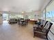 Sunroom featuring modern furniture, lots of natural light, views of the beach, and tiled flooring at 4725 Cove Circle # 908, St Petersburg, FL 33708