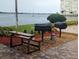 Community outdoor grills with a picnic table and serene views, perfect for gatherings at 4725 Cove Circle # 908, St Petersburg, FL 33708