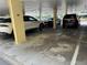 View of parking garage with covered parking spots for residents, and various personal vehicles at 4725 Cove Circle # 908, St Petersburg, FL 33708
