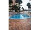 Outdoor pool surrounded by brick pavers and white fencing for a private and luxurious swimming experience at 4725 Cove Circle # 908, St Petersburg, FL 33708