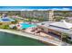 Community pool with lounging area and palm trees near the clubhouse and waterfront at 4725 Cove Circle # 908, St Petersburg, FL 33708
