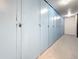 Long row of blue storage lockers in a hallway with combination locks on the doors at 4725 Cove Circle # 908, St Petersburg, FL 33708
