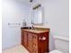 Bathroom features a wooden vanity with granite countertop and a white toilet at 504 Riverside Dr # 504, Tarpon Springs, FL 34689