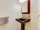 Small bathroom featuring a pedestal sink and a unique tile backsplash at 504 Riverside Dr # 504, Tarpon Springs, FL 34689