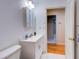 Clean bathroom featuring a white vanity with modern fixtures and a view into an adjacent room at 504 Riverside Dr # 504, Tarpon Springs, FL 34689
