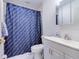 Bathroom featuring a blue patterned shower curtain, classic white toilet, and vanity at 504 Riverside Dr # 504, Tarpon Springs, FL 34689