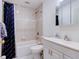 Bright bathroom with a shower-tub combo, white fixtures, a blue patterned shower curtain, and ample lighting at 504 Riverside Dr # 504, Tarpon Springs, FL 34689