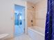 Bathroom showcasing a jacuzzi tub, tiled walls and a view into an adjacent bedroom at 504 Riverside Dr # 504, Tarpon Springs, FL 34689