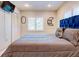 Bright bedroom featuring a cozy bed with a blue headboard, neutral bedding, and natural light from shuttered windows at 504 Riverside Dr # 504, Tarpon Springs, FL 34689